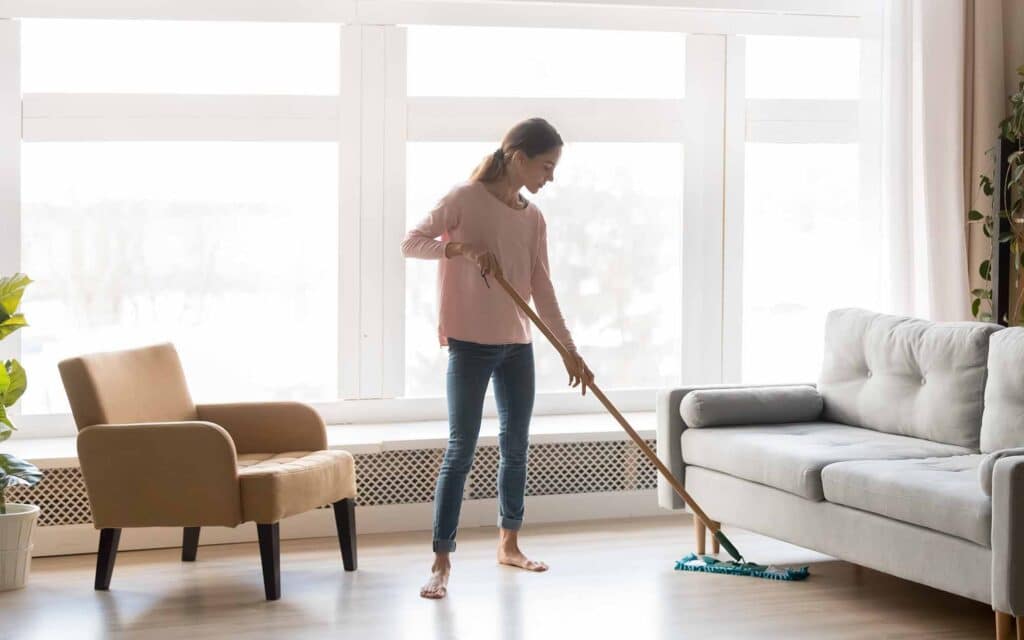 woman cleaning the floor with a mop