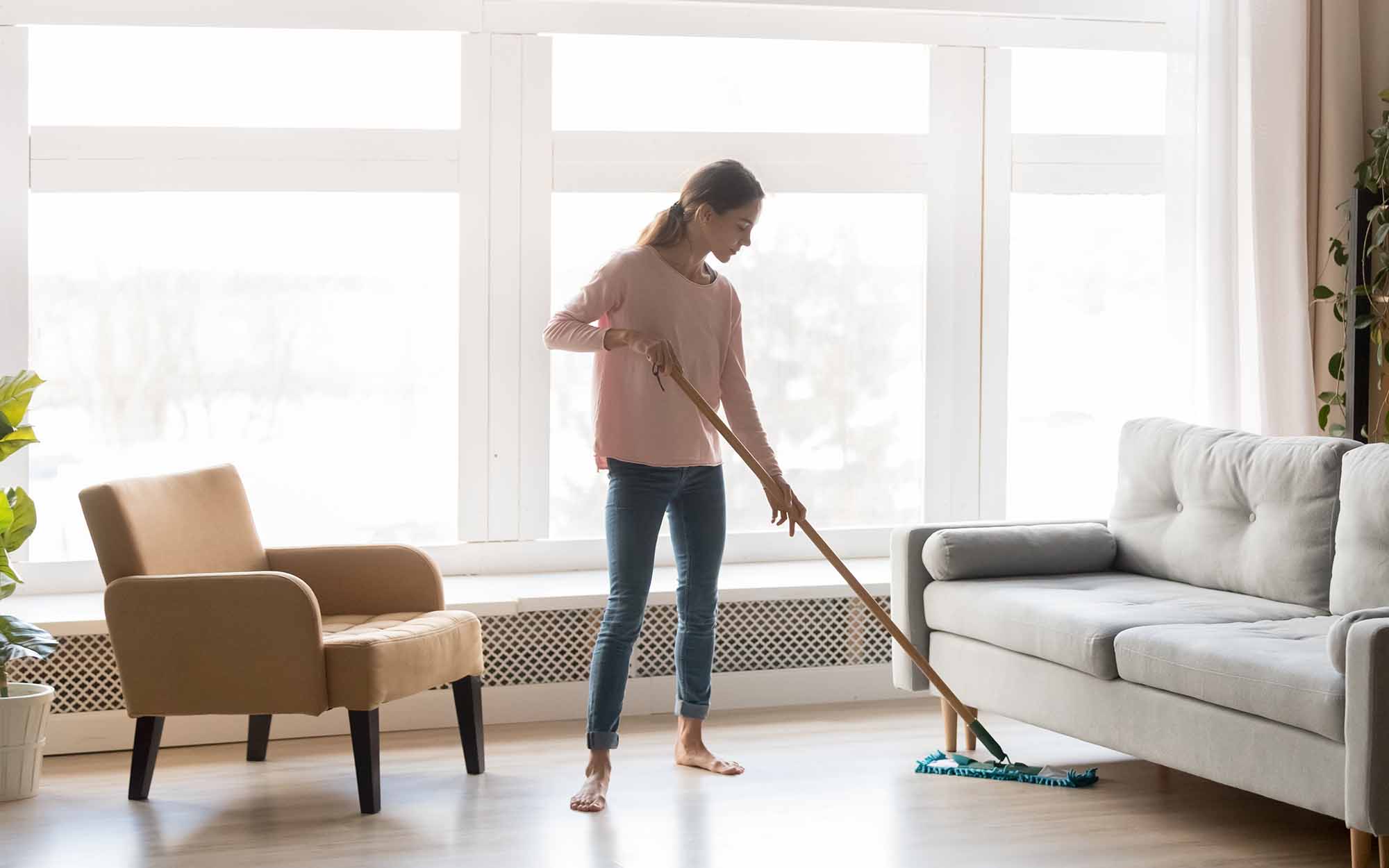 woman cleaning the floor with a mop